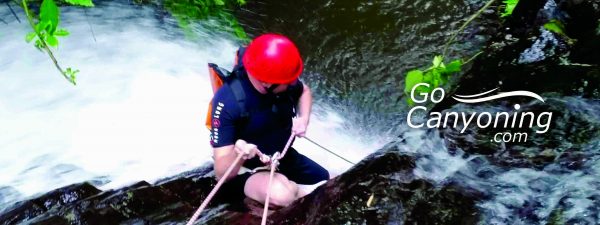 Man abseiling in to rapids